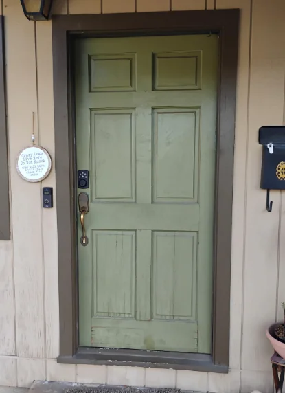 Weathered painted wood front door before replacement in Novato, California