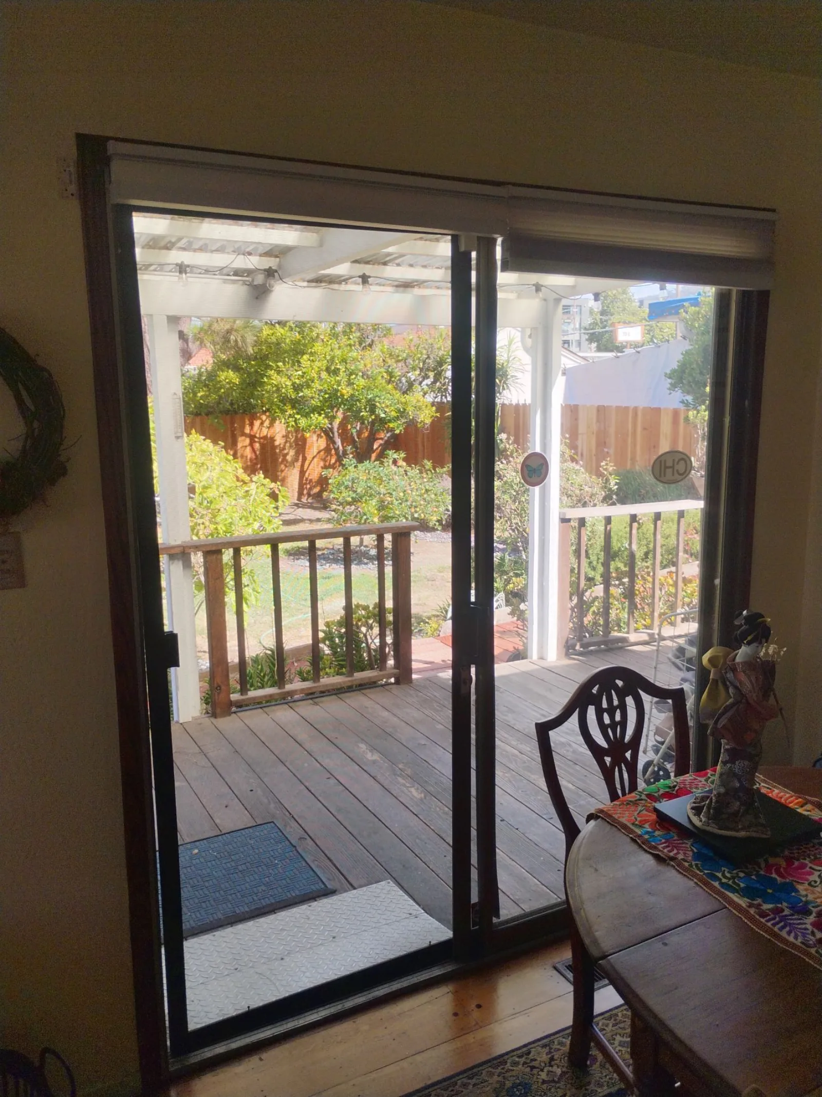 Old single-pane aluminum sliding patio door before replacement