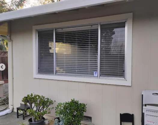Original aluminum window with blinds before replacement in Danville