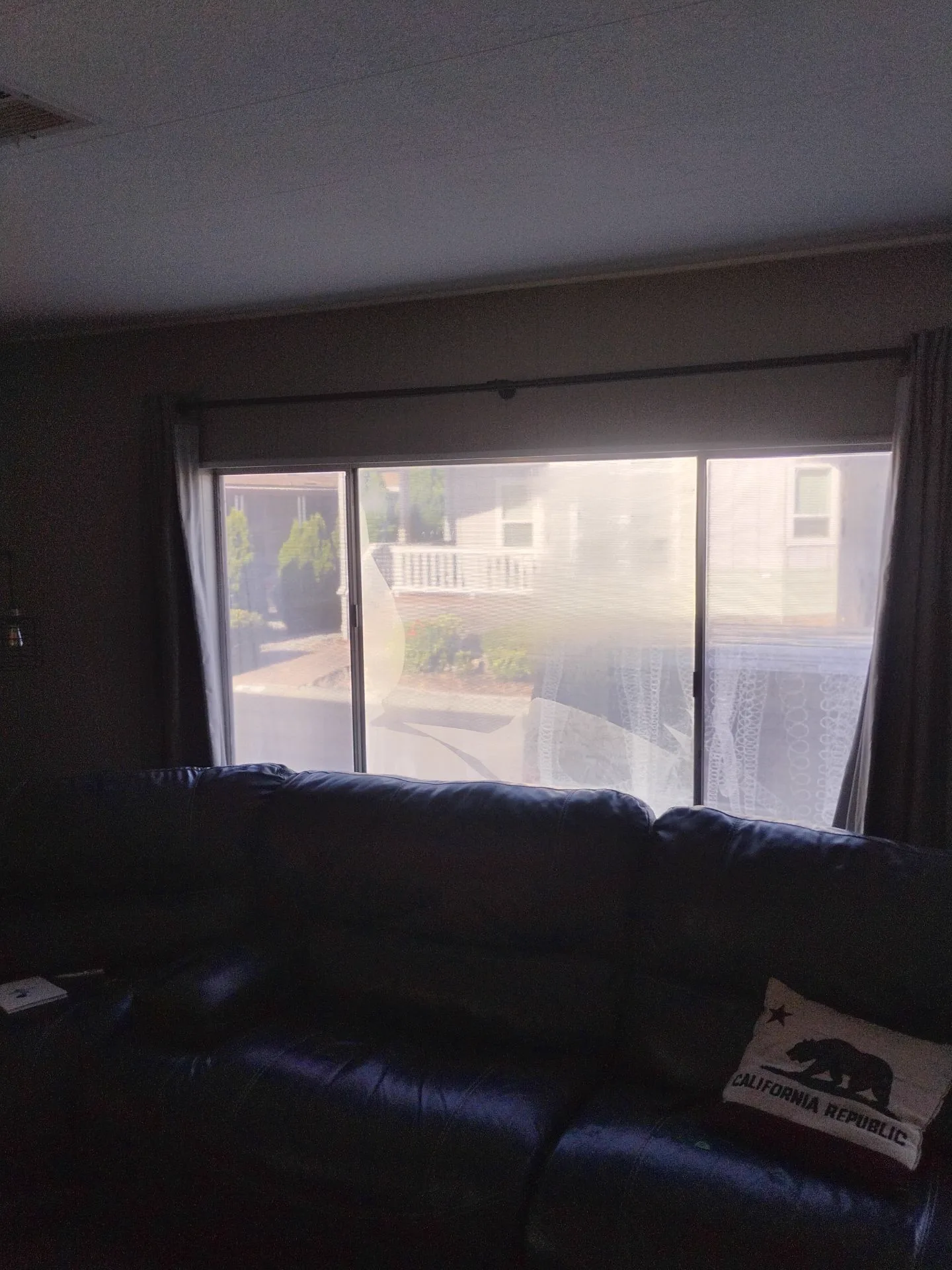 Older aluminum-framed living room window before window replacement in San Jose, CA