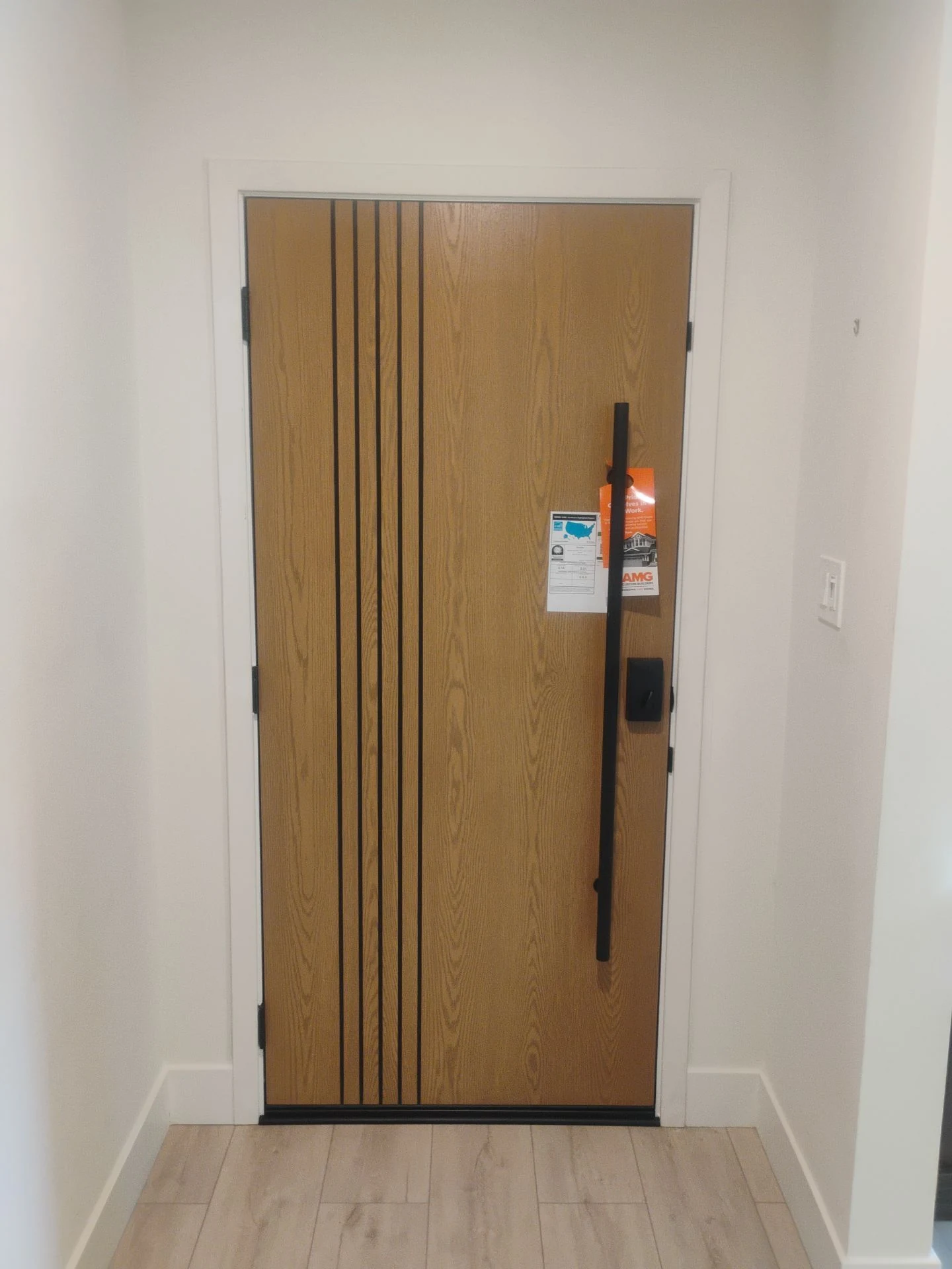 Interior view of the completed ProVia Ascent entry door with black lever hardware in Pleasanton, CA