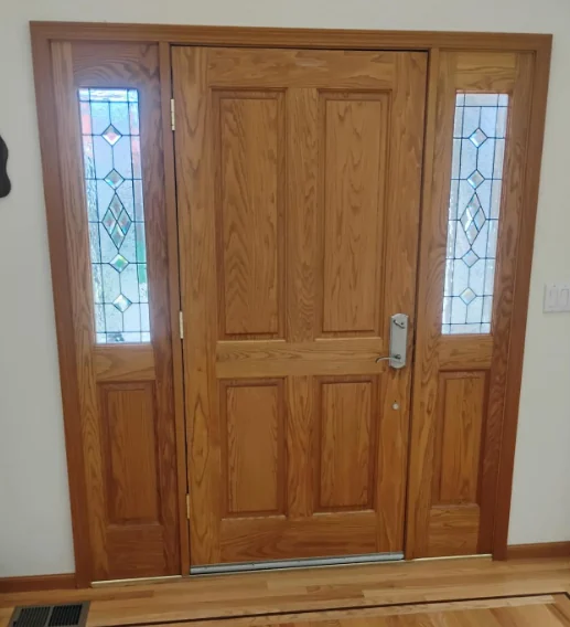 Interior view of the original wood entry door and sidelites in a Larkspur home