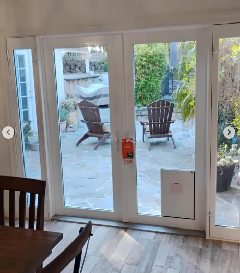 Integrated XL dog door built into an Anlin Malibu French patio door
