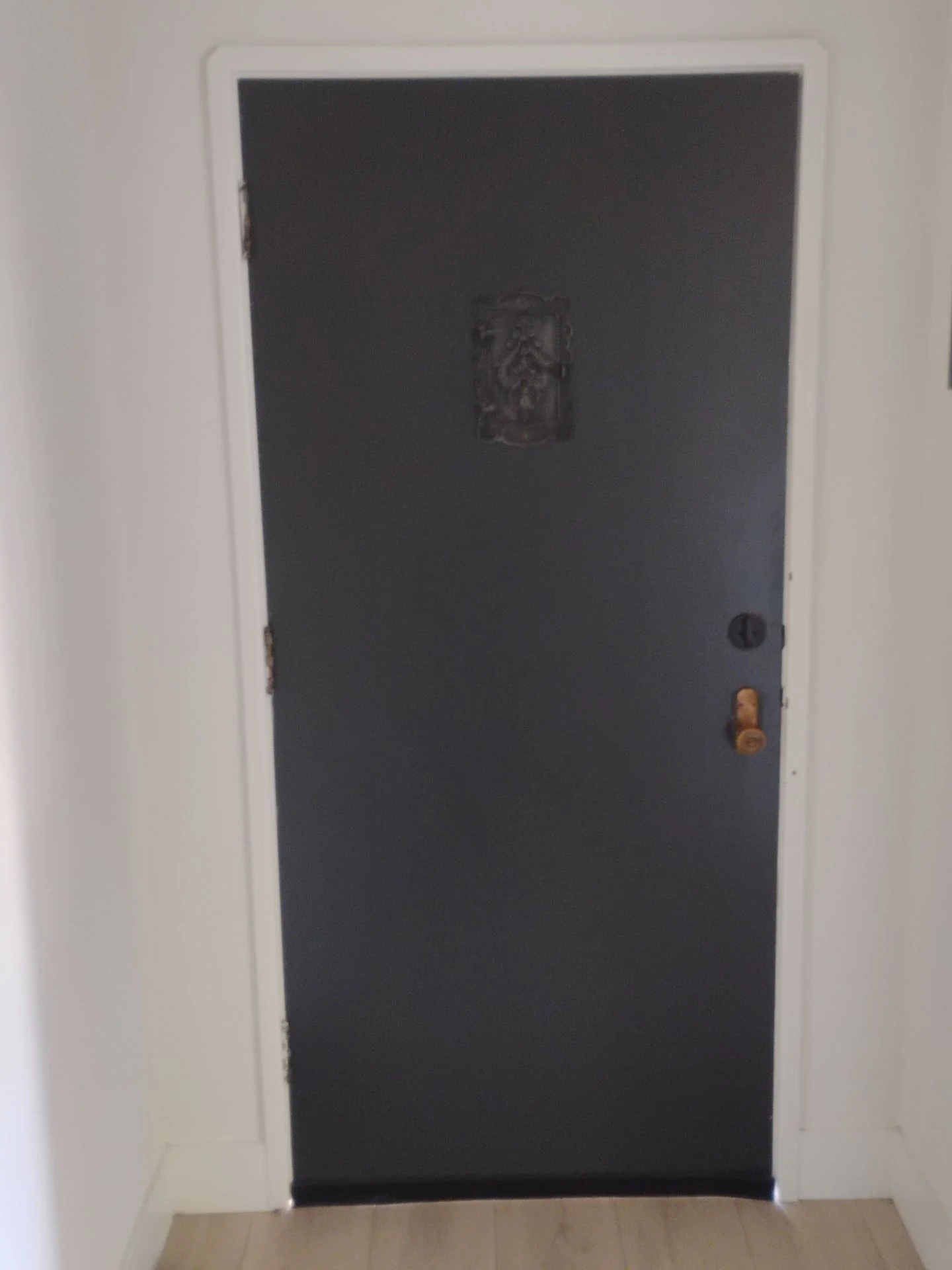 Interior view of the original dark entry door before replacement in Pleasanton, CA
