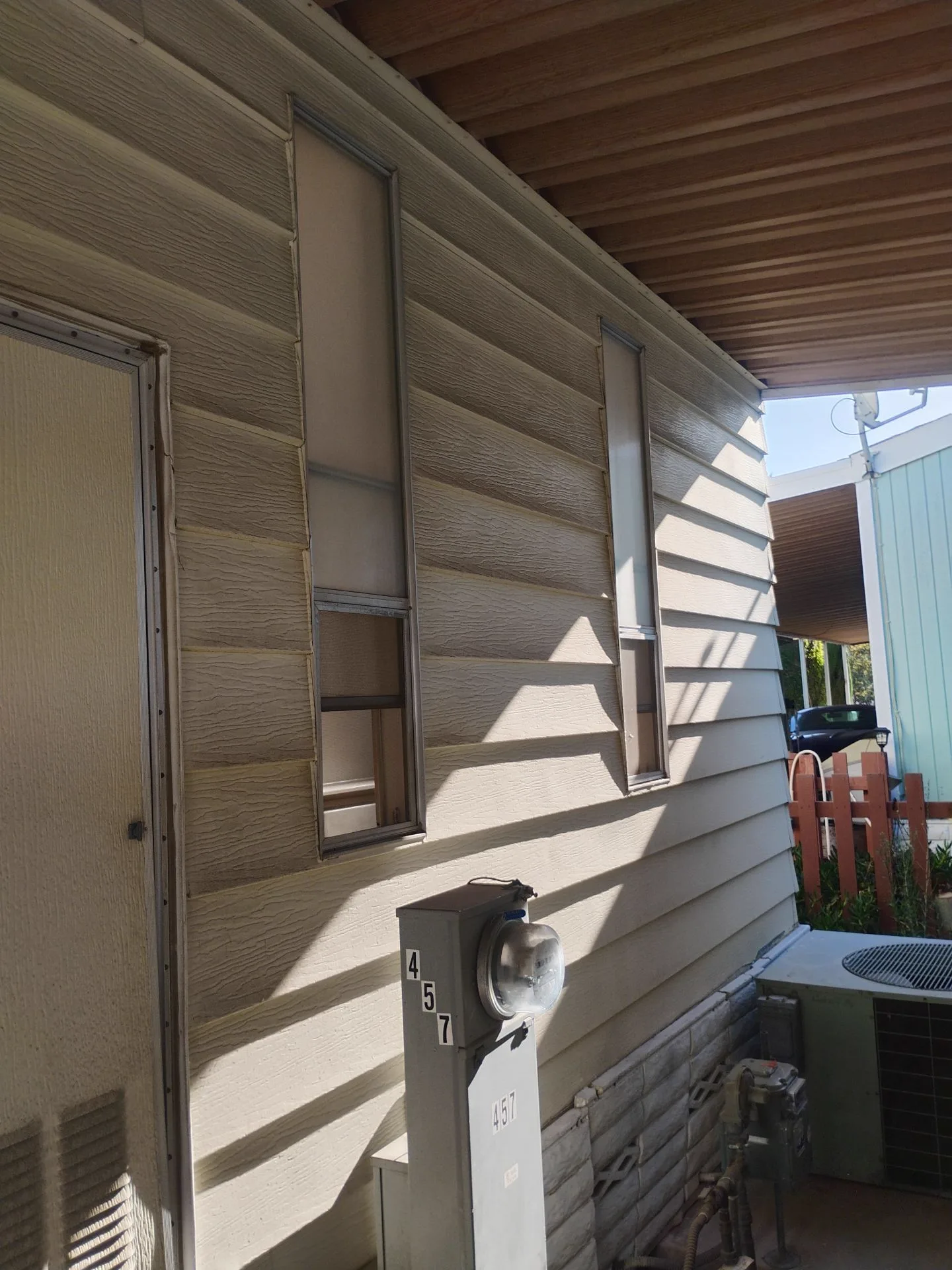 Older aluminum windows on the side elevation of a San Jose, CA home