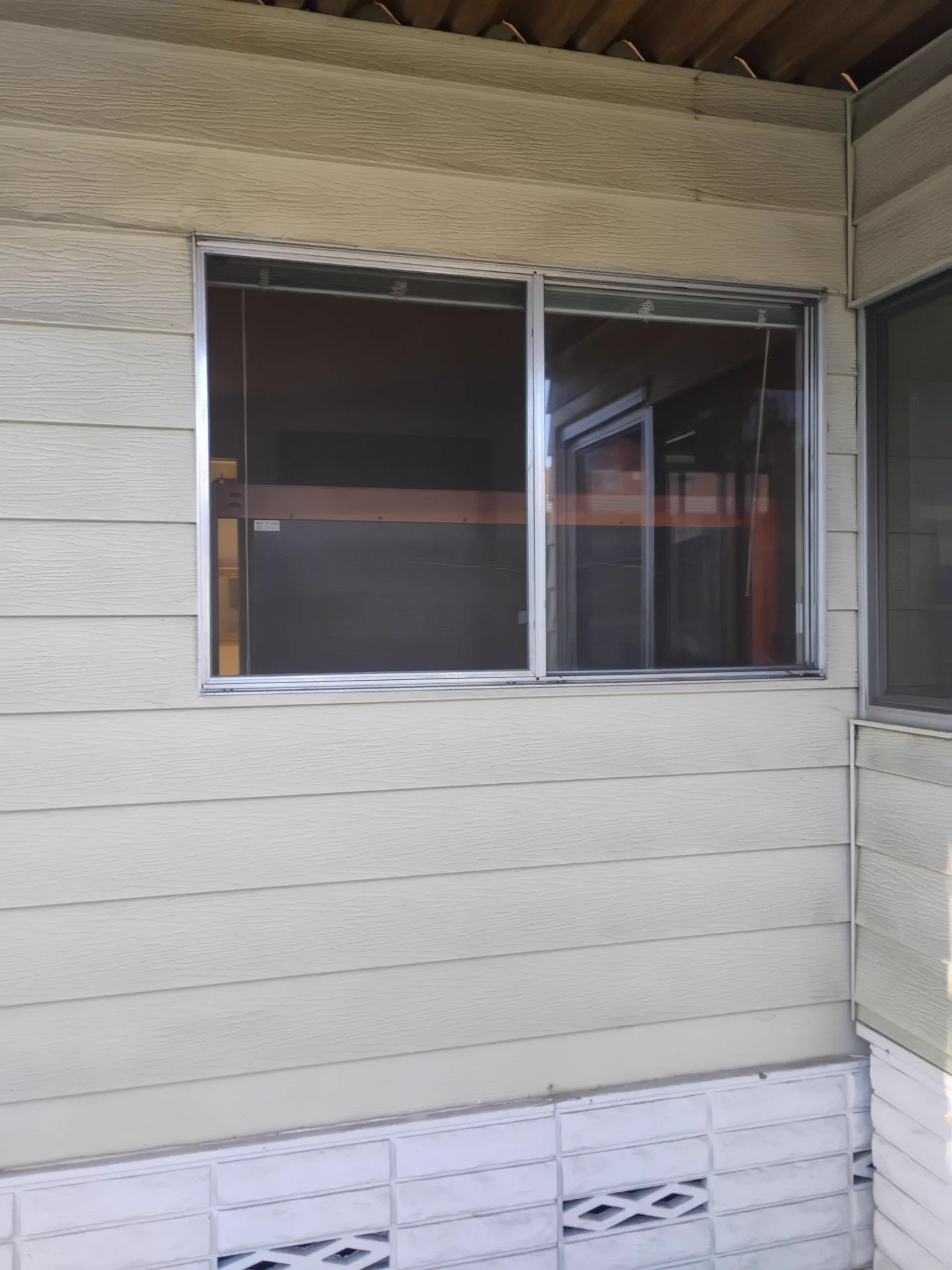 Older aluminum slider window exterior before replacement in San Jose, CA