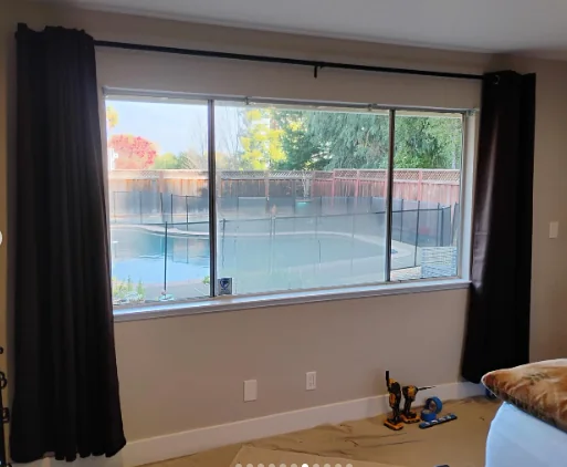 Older aluminum windows before replacement in a Danville room overlooking the pool