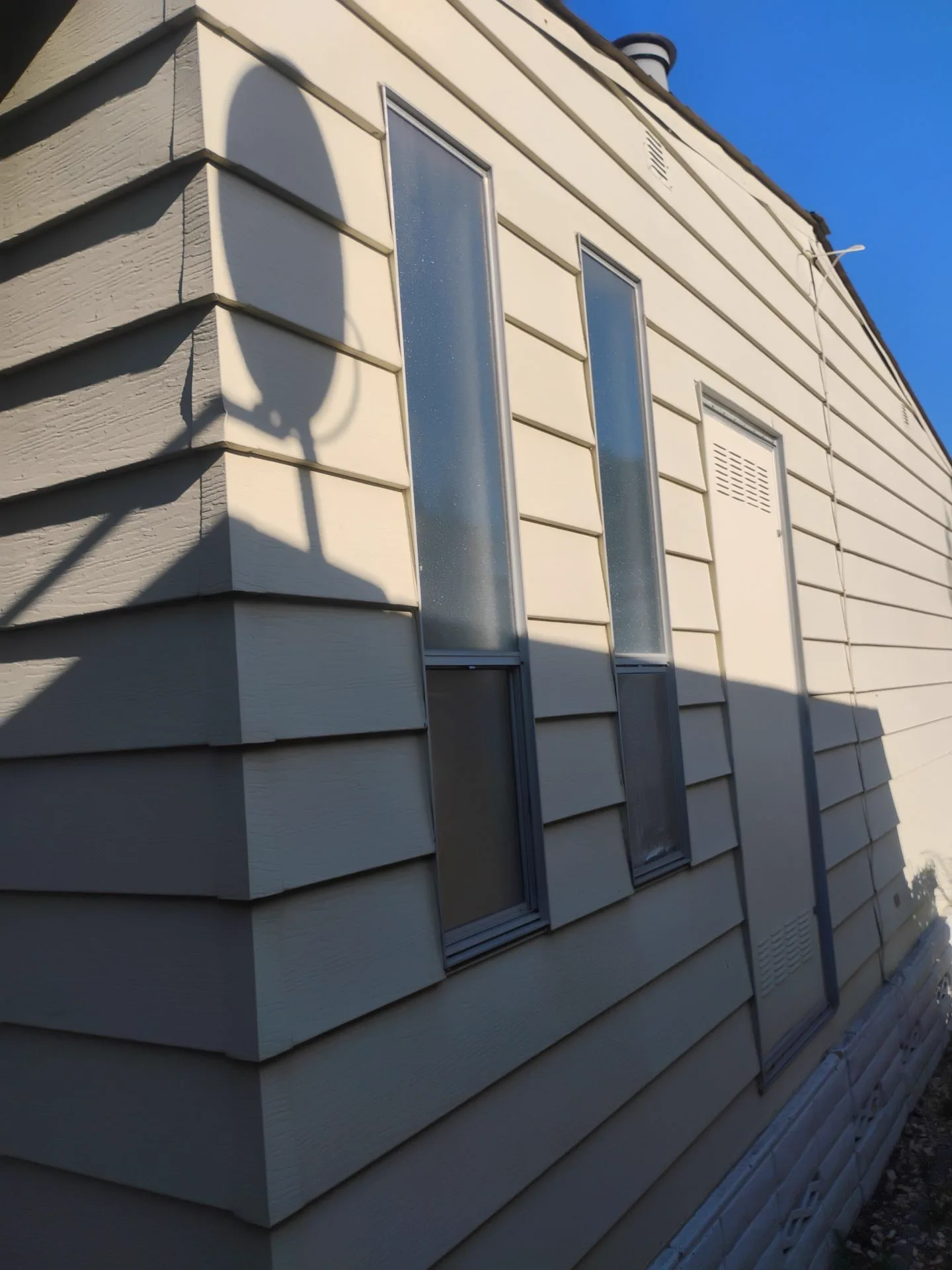 Exterior view of older aluminum-framed windows in San Jose, CA