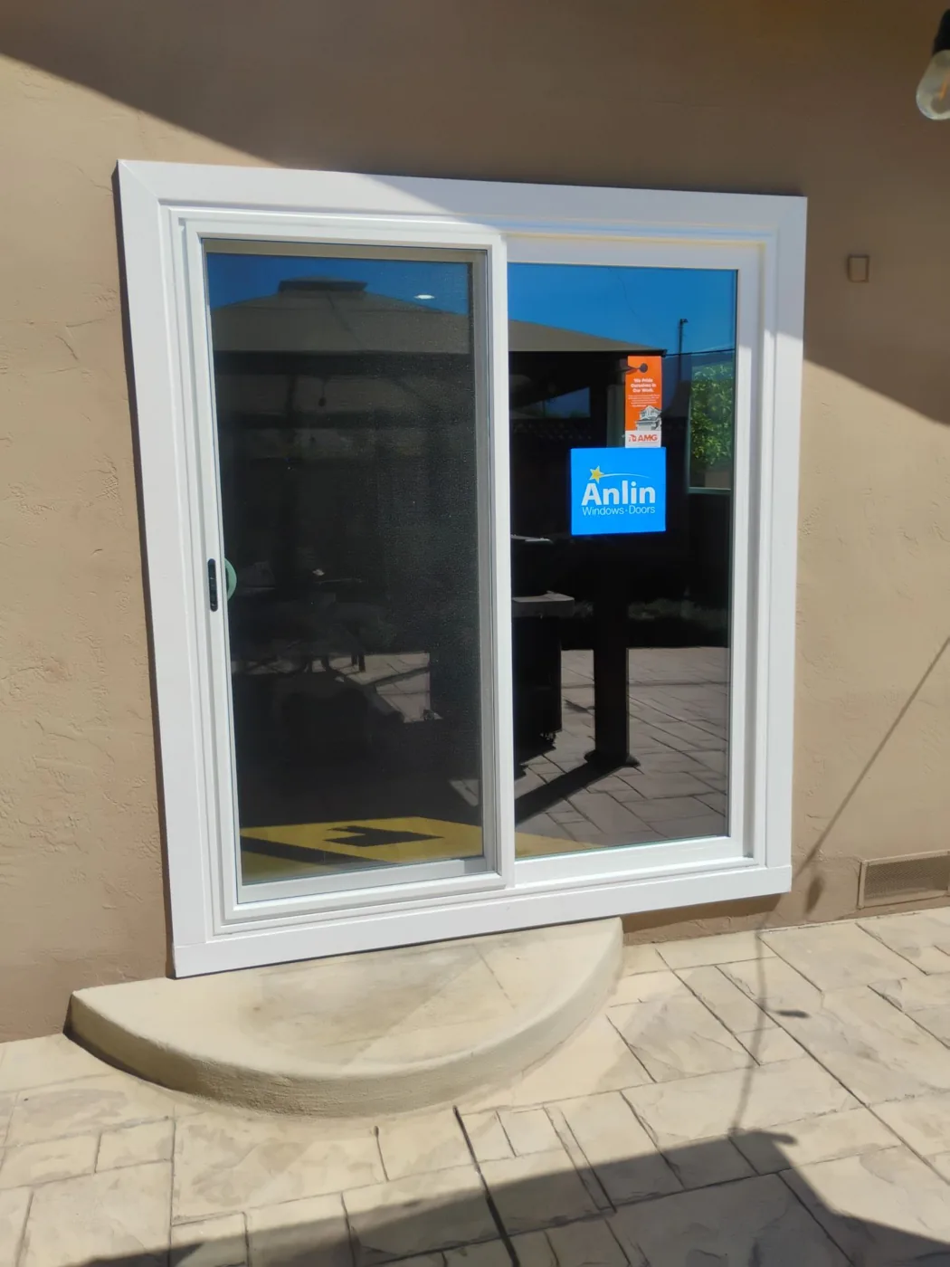 Exterior view of the two-panel Anlin Malibu patio door with its clean white vinyl frame set into the stucco wall