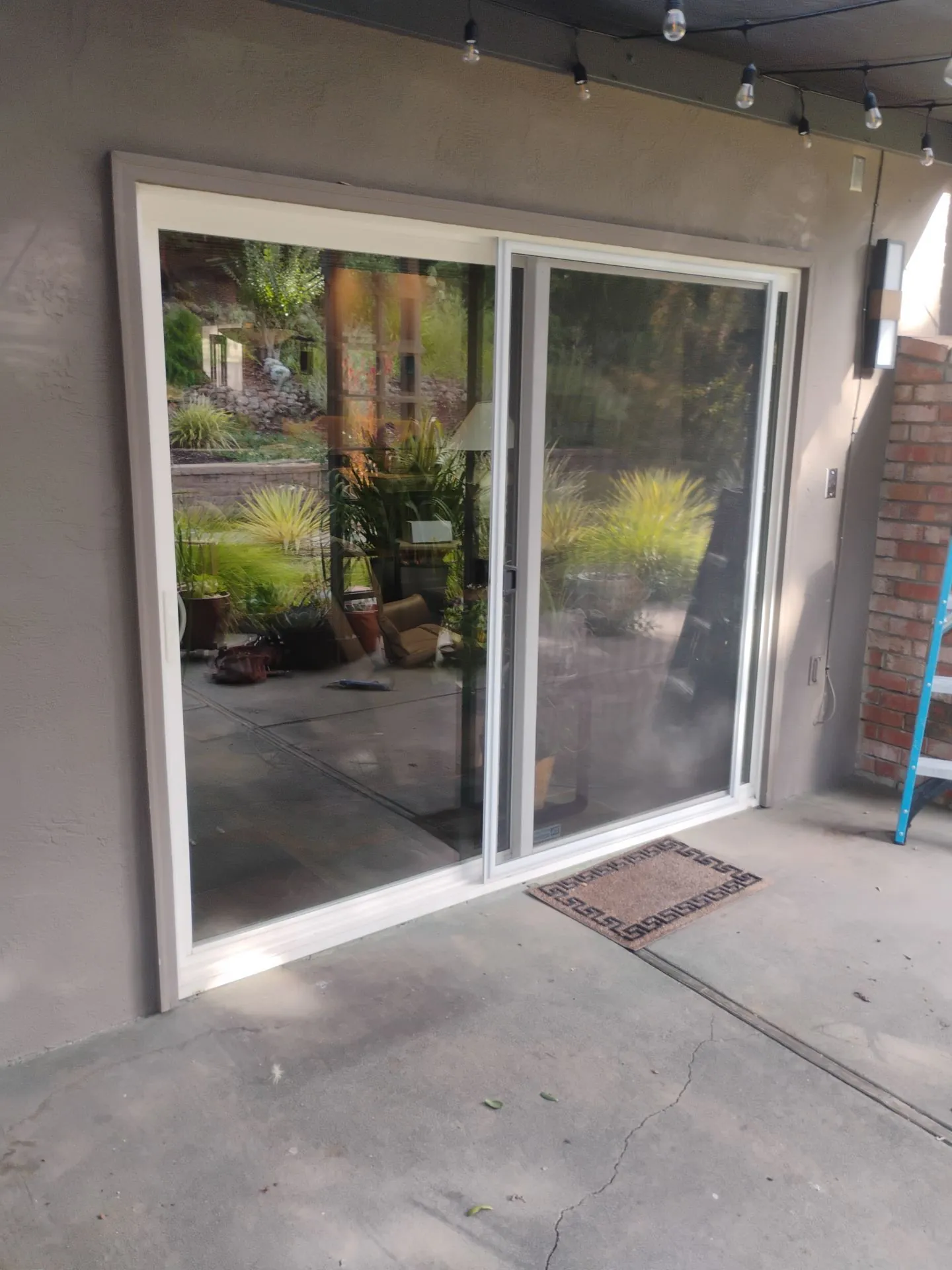 Before: the second white-frame sliding patio door opening seen from the patio of the Danville, CA home