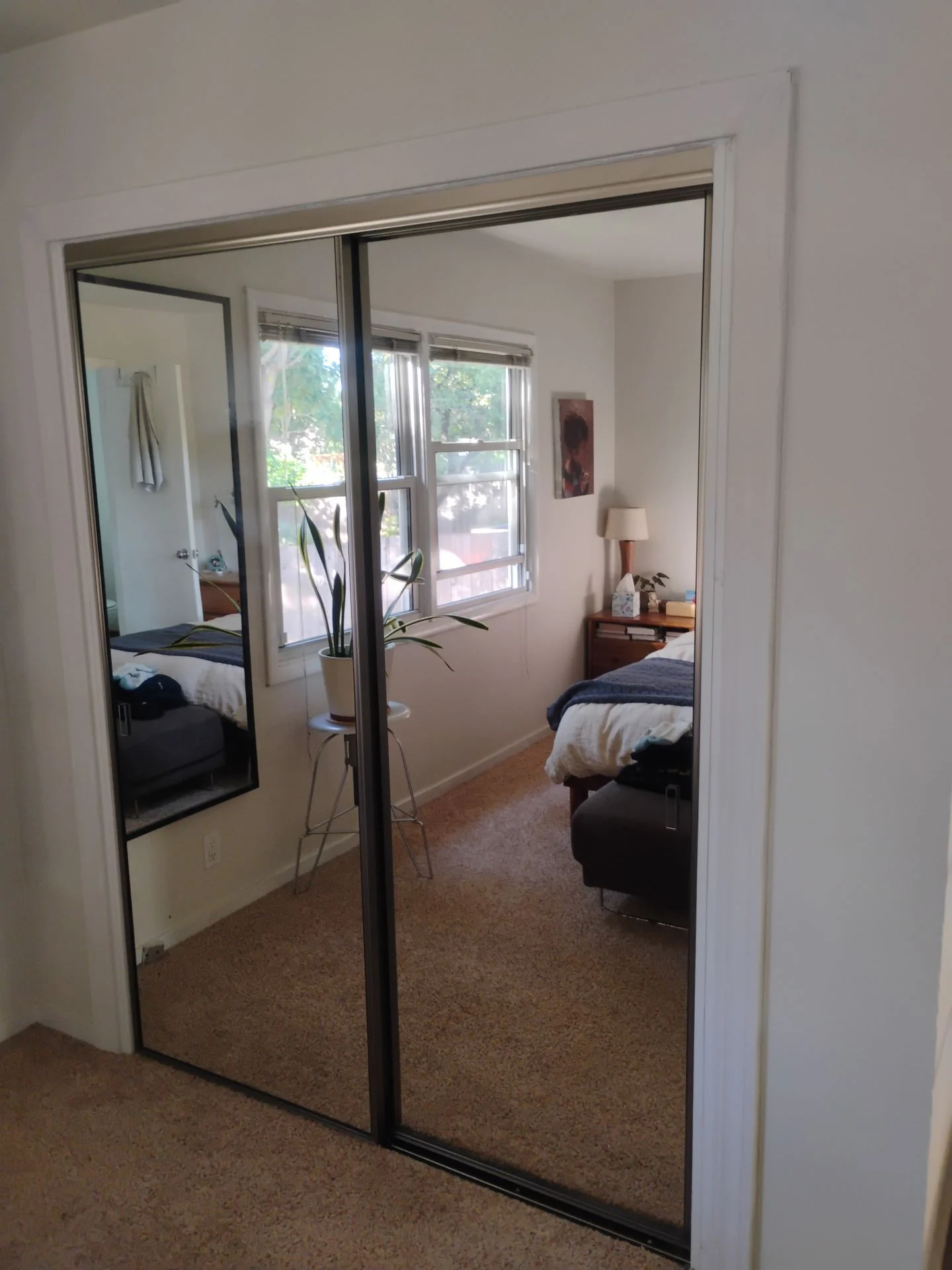 After: bedroom mirrored closet doors with dark frames and new casing following the San Carlos, CA interior door replacement