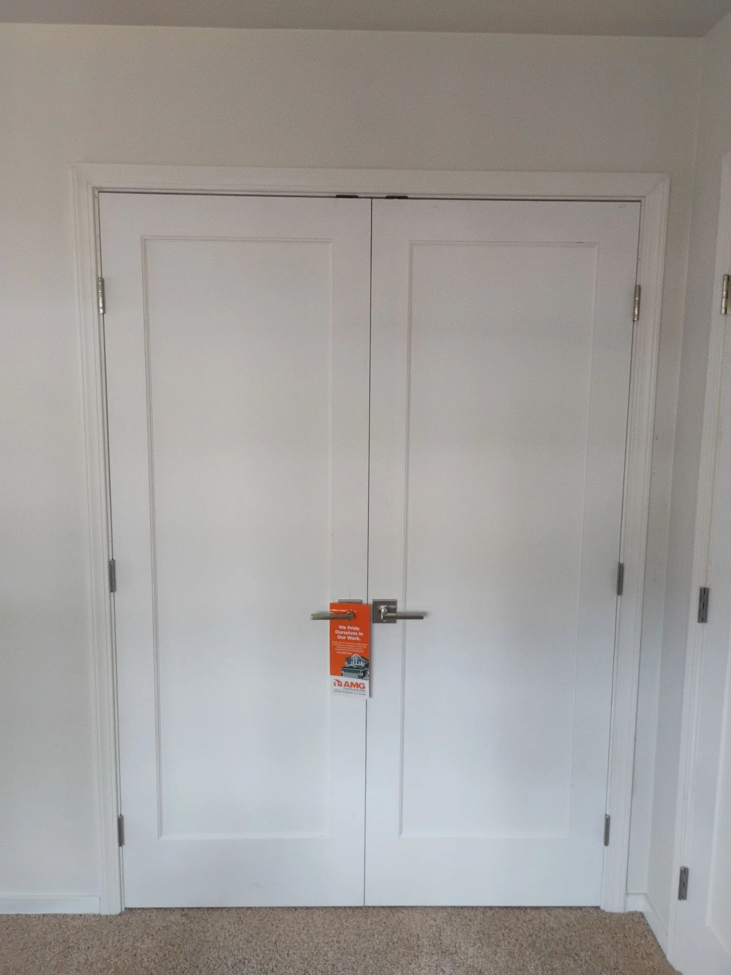 After: double closet doors in the matching single-panel Shaker style with satin-nickel levers, San Carlos, CA interior door project