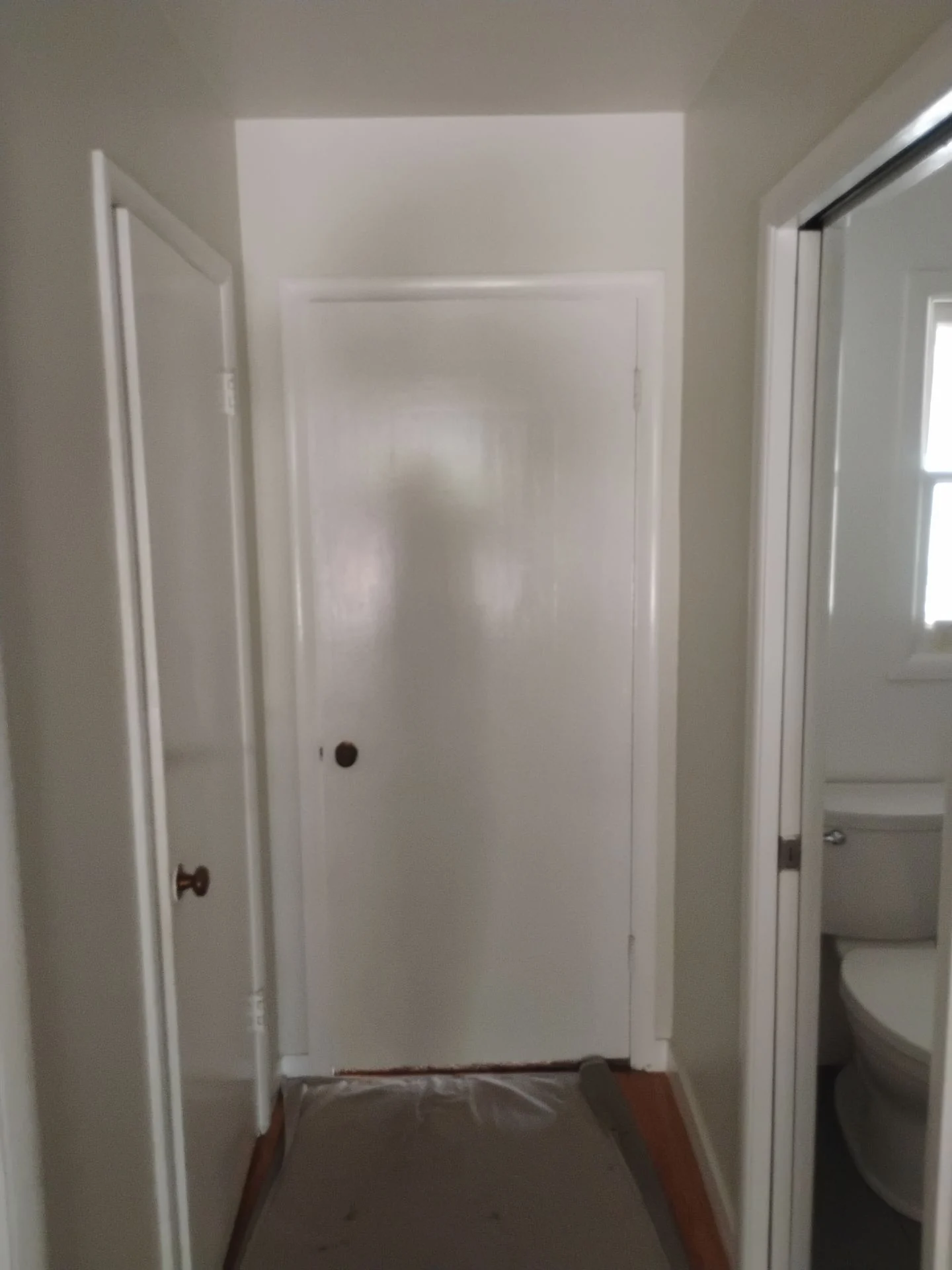 Before: original bathroom door and worn casing in the San Carlos, CA hallway