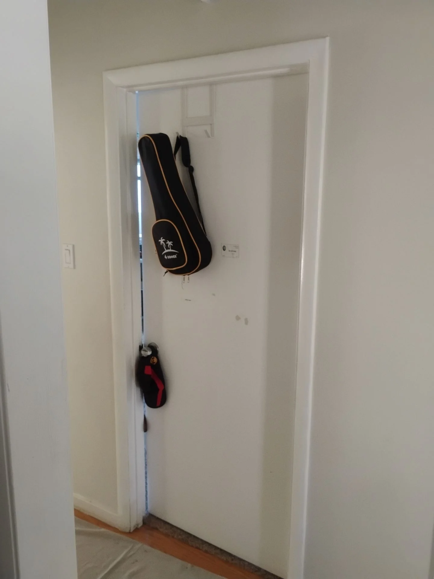 Before: hallway interior door with old painted casing and uneven reveals prior to replacement, San Carlos, CA