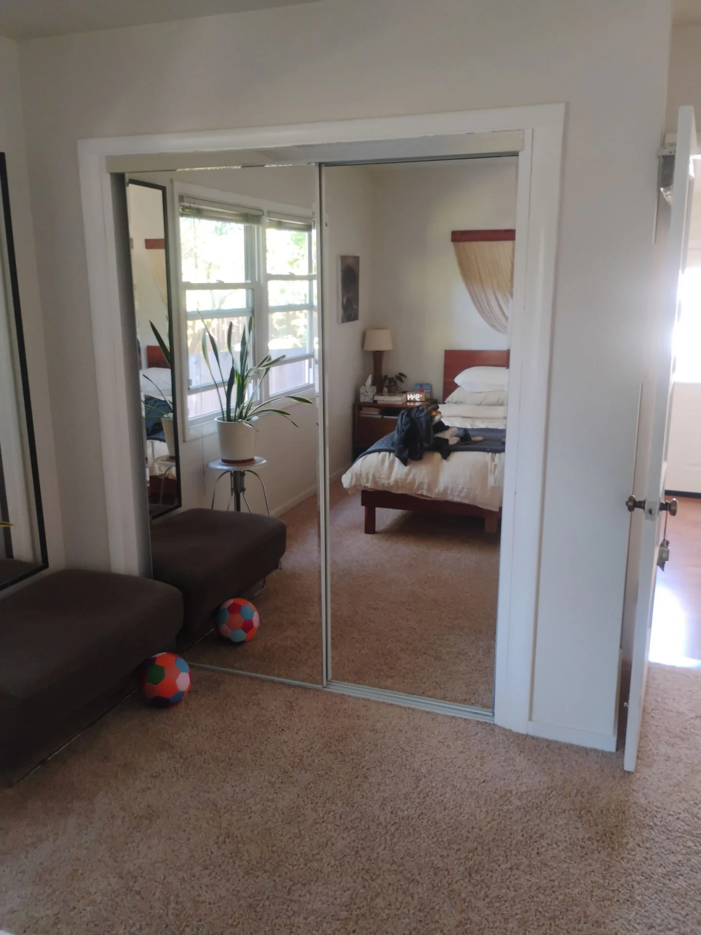 Before: original mirrored closet doors with light metal frames in the San Carlos, CA bedroom