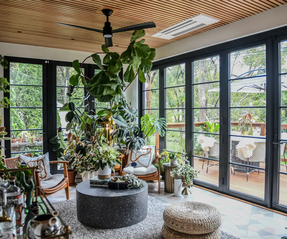 Bay Area home at twilight with full-height Andersen black-frame architectural windows glowing warm interior light