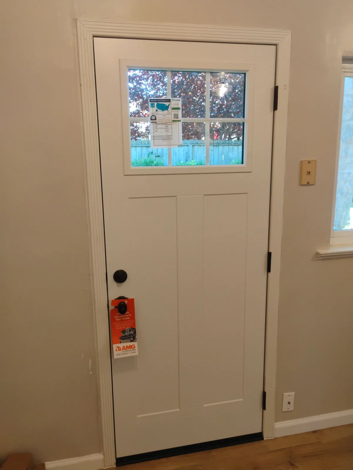 Interior view of the new ProVia Legacy Craftsman 420 steel entry door in Snow Mist white with clear ComforTech glass and a cottage six-lite grid in Pleasant Hill, CA