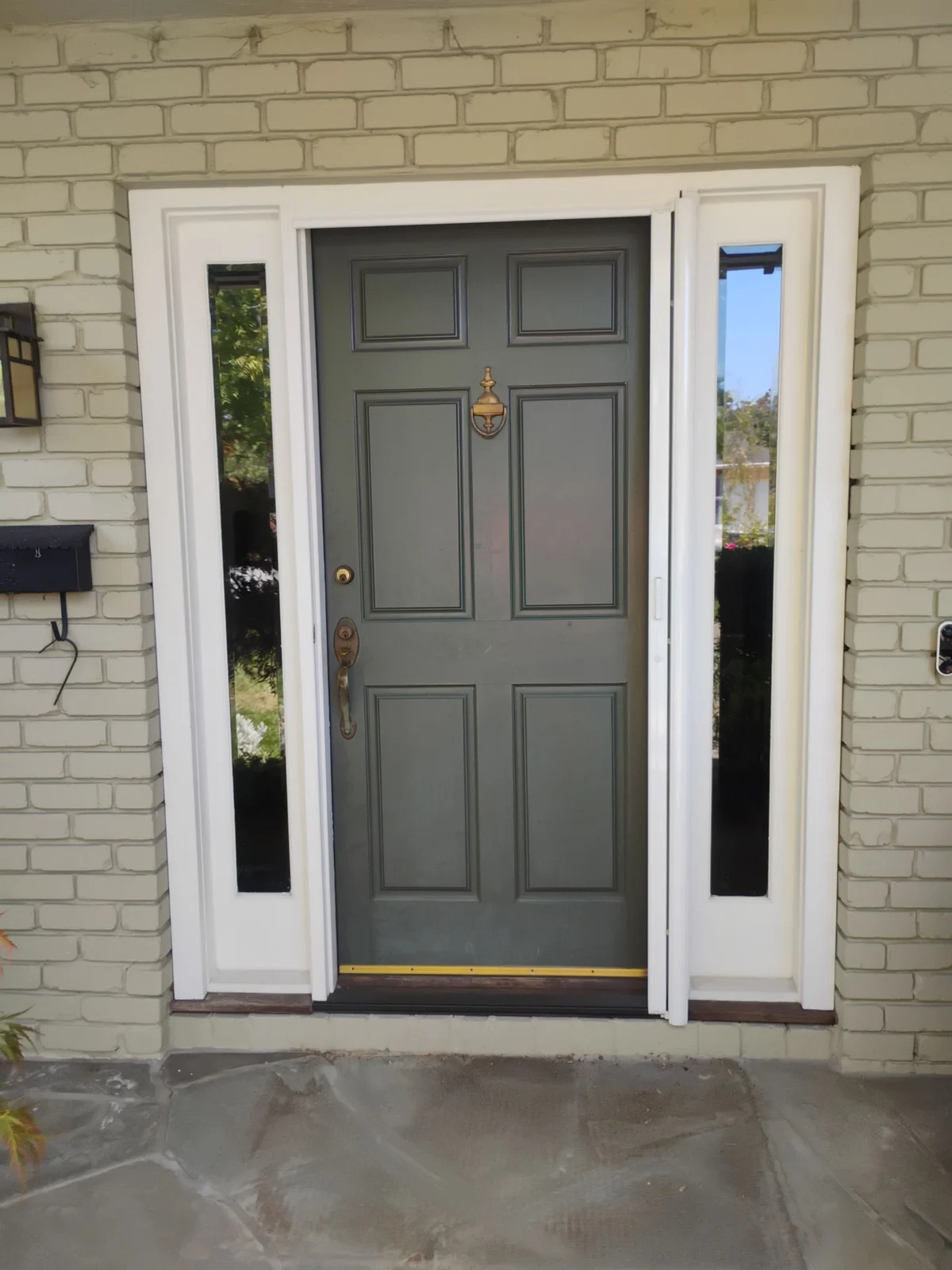 Aging wood front door before replacement in Danville