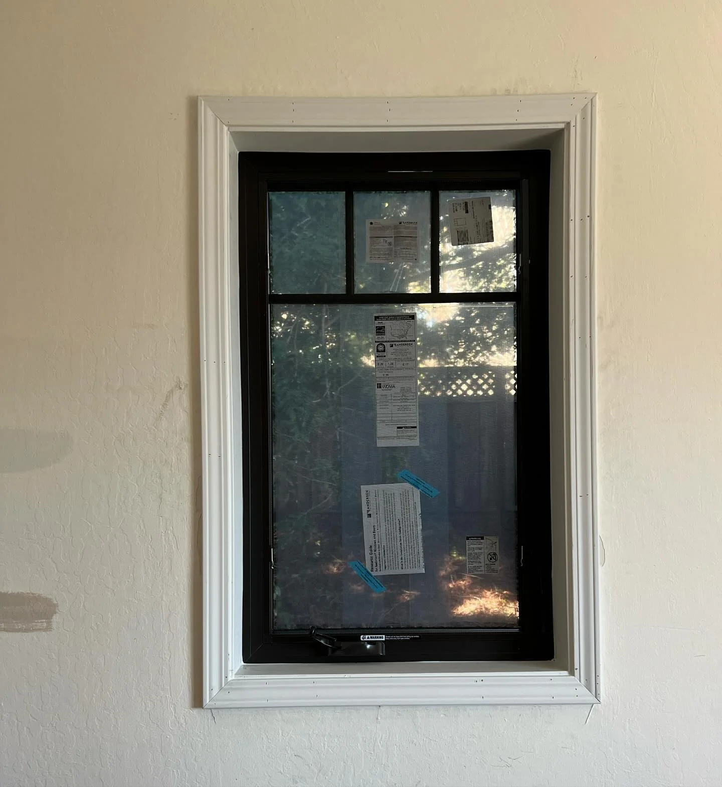 Narrow black Andersen 100 Series replacement window with white trim in Danville California
