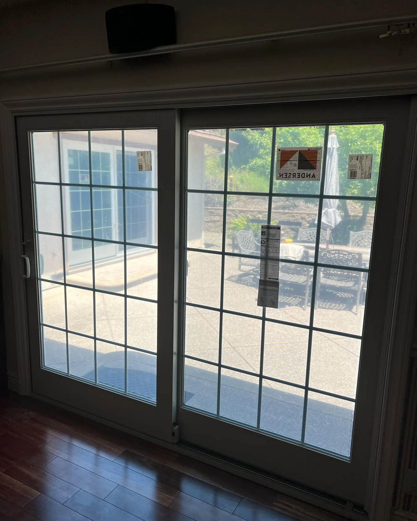 Interior view of a white Andersen 400 Series gliding patio door with divided-light glass in Danville, California