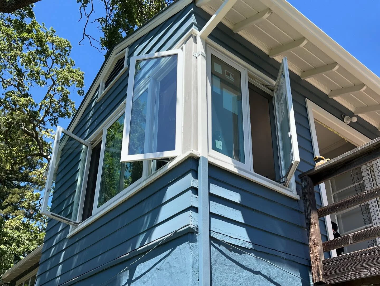 Exterior close view of open Andersen E-Series casement windows installed on an Orinda home