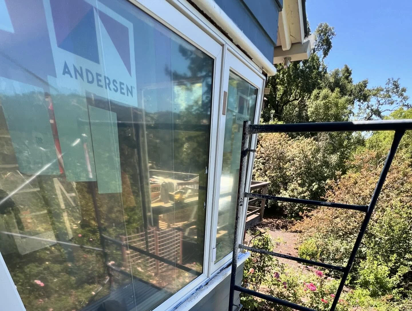 Close exterior installation view of an Andersen E-Series window and product label in Orinda