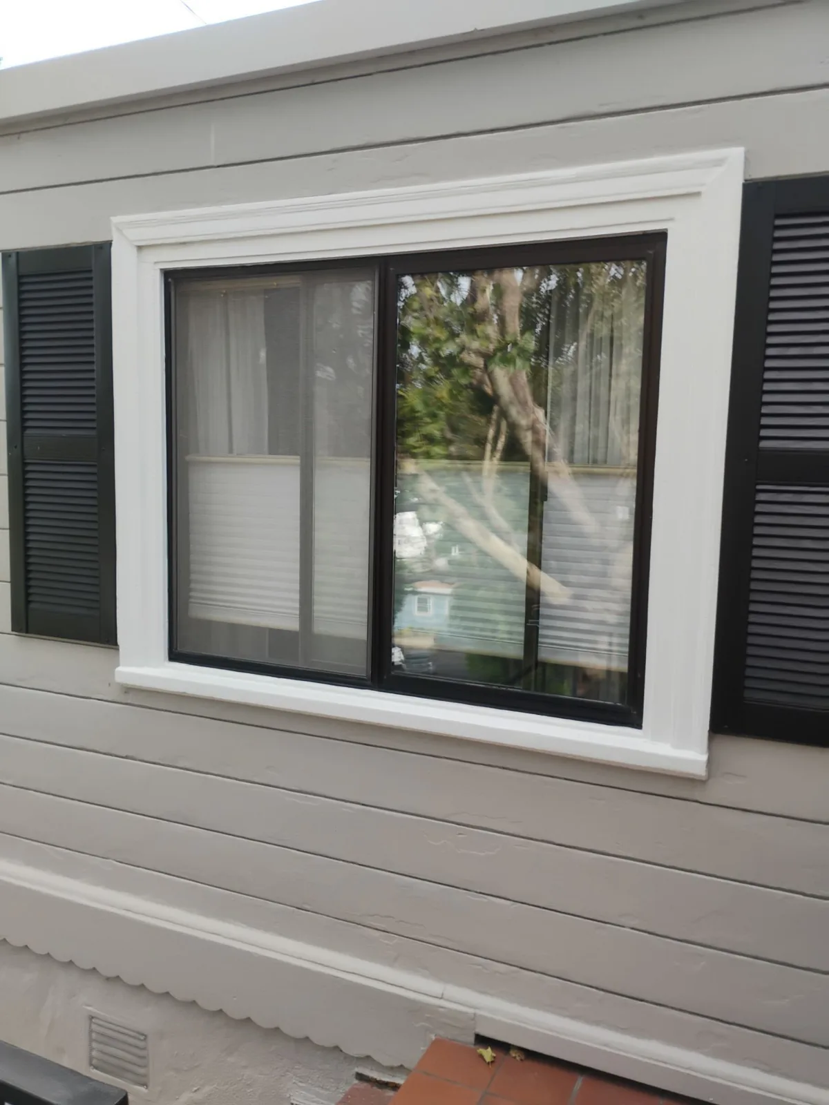 Before and after window replacement in Martinez California — original dark-framed window before replacement