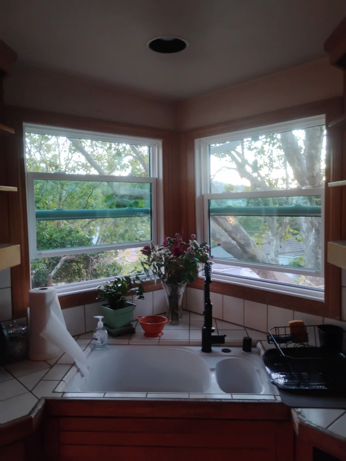 Bright kitchen corner with new Anlin windows overlooking the trees in Martinez