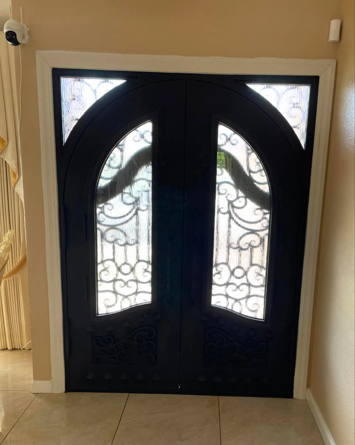 Interior view of custom double wrought iron front door with privacy glass in Hayward California