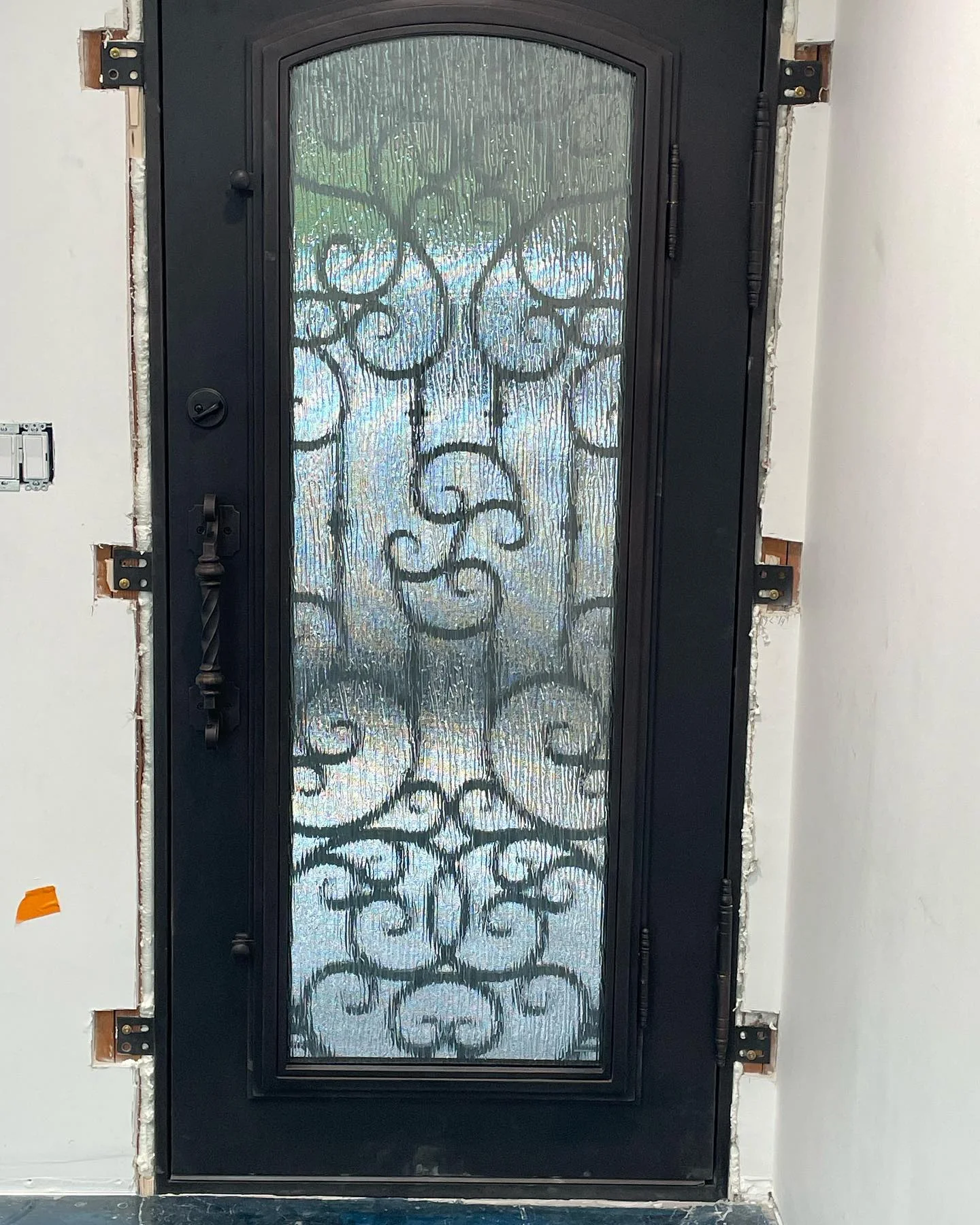 Interior installation view of decorative iron front door with privacy glass in Danville California