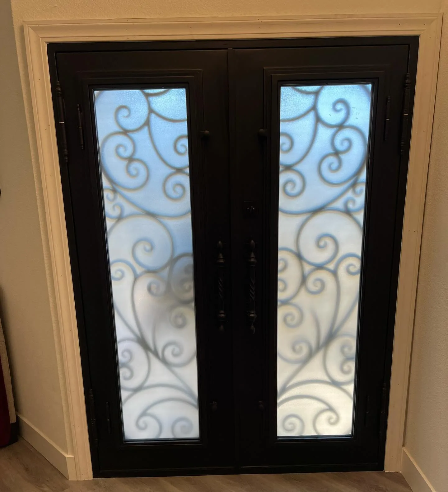 Interior view of double wrought iron front door with privacy glass installed in Tracy California