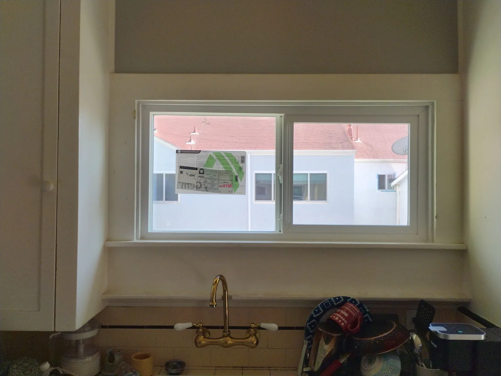 Completed white dual-pane kitchen window in Hayward, California