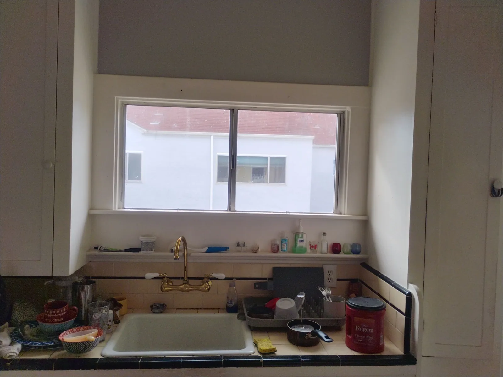 Older aluminum kitchen window before the Hayward installation