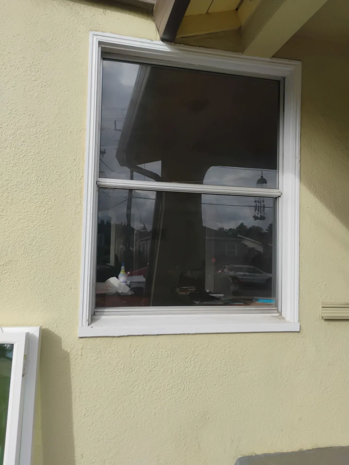 Interior view of an old aluminum window before the dual-pane upgrade