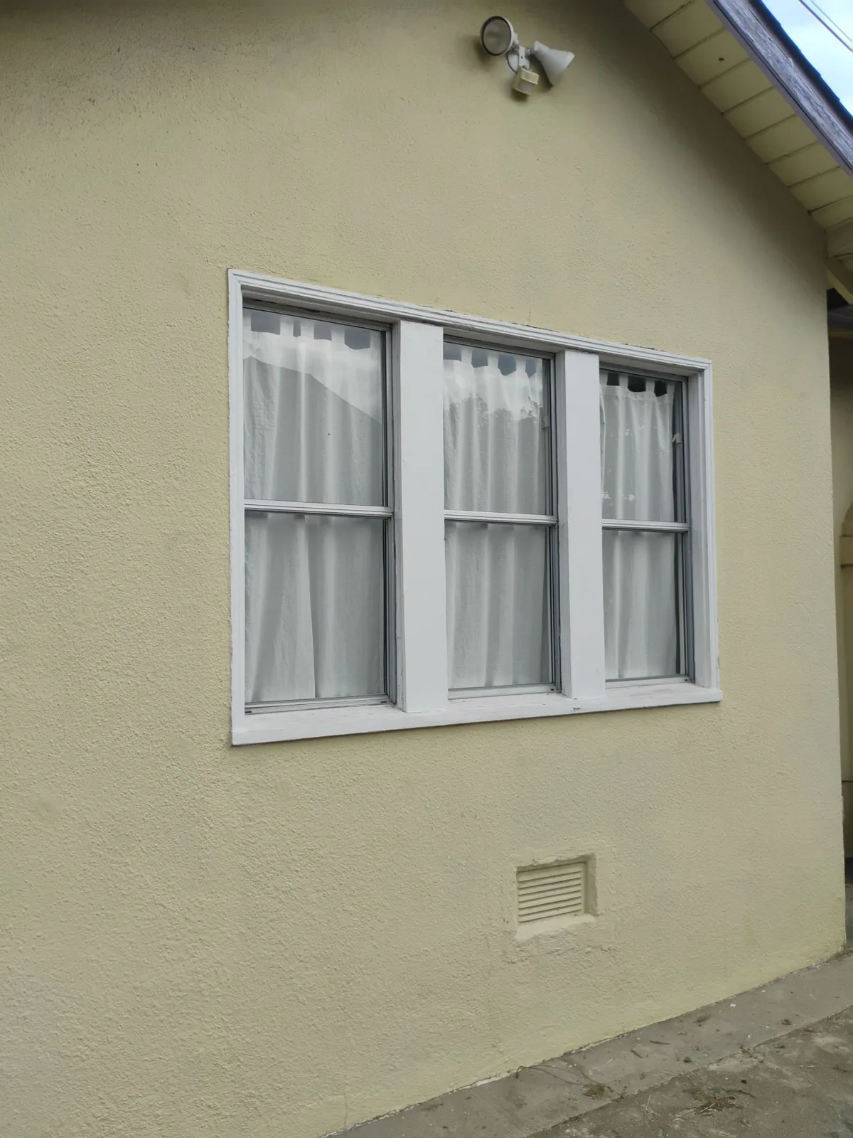Original aluminum window at the Hayward home prior to removal