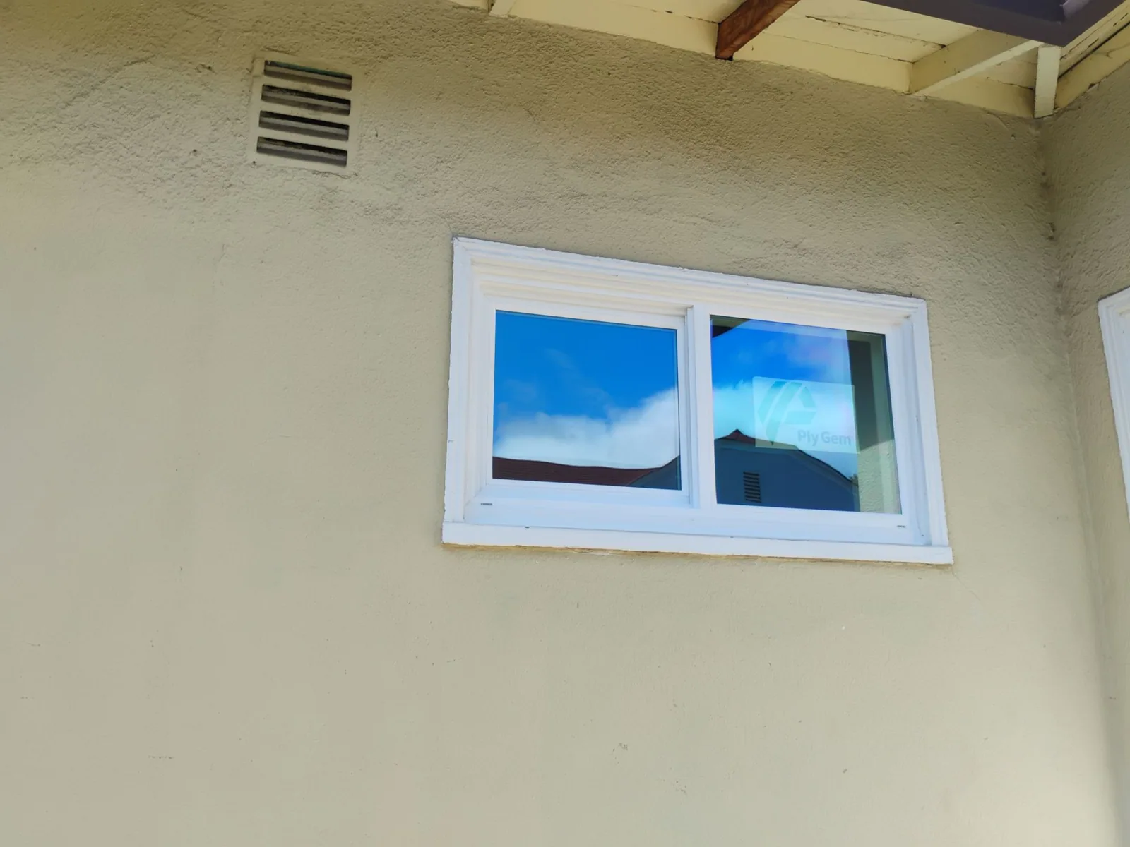 White dual-pane Ply Gem window set into the home's stucco wall in Hayward