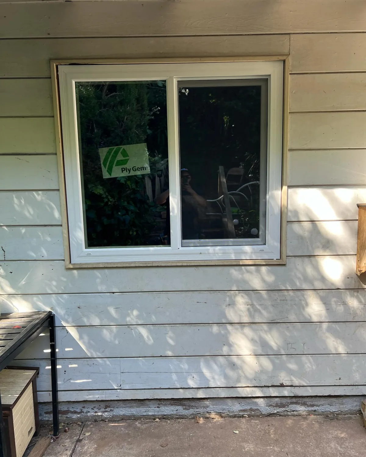 White PlyGem replacement window installed above an exterior stairway in Oakland, California