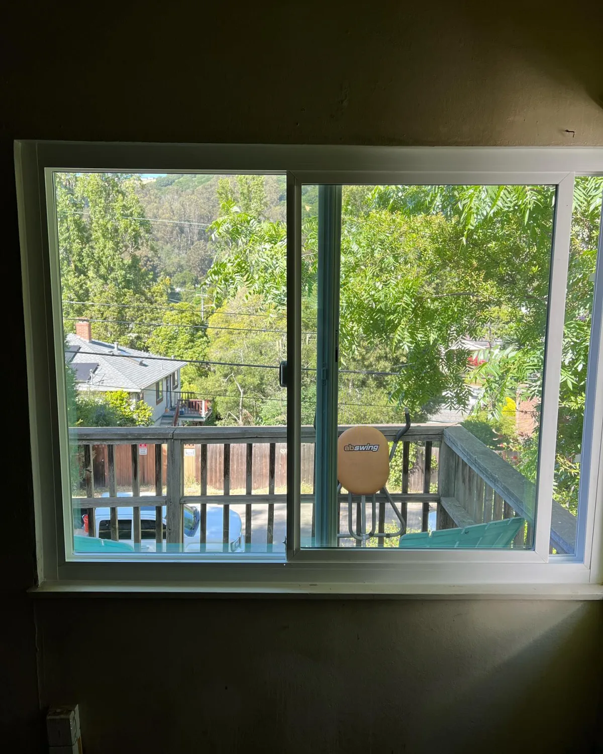 Large PlyGem horizontal sliding window with a backyard view in Oakland, California