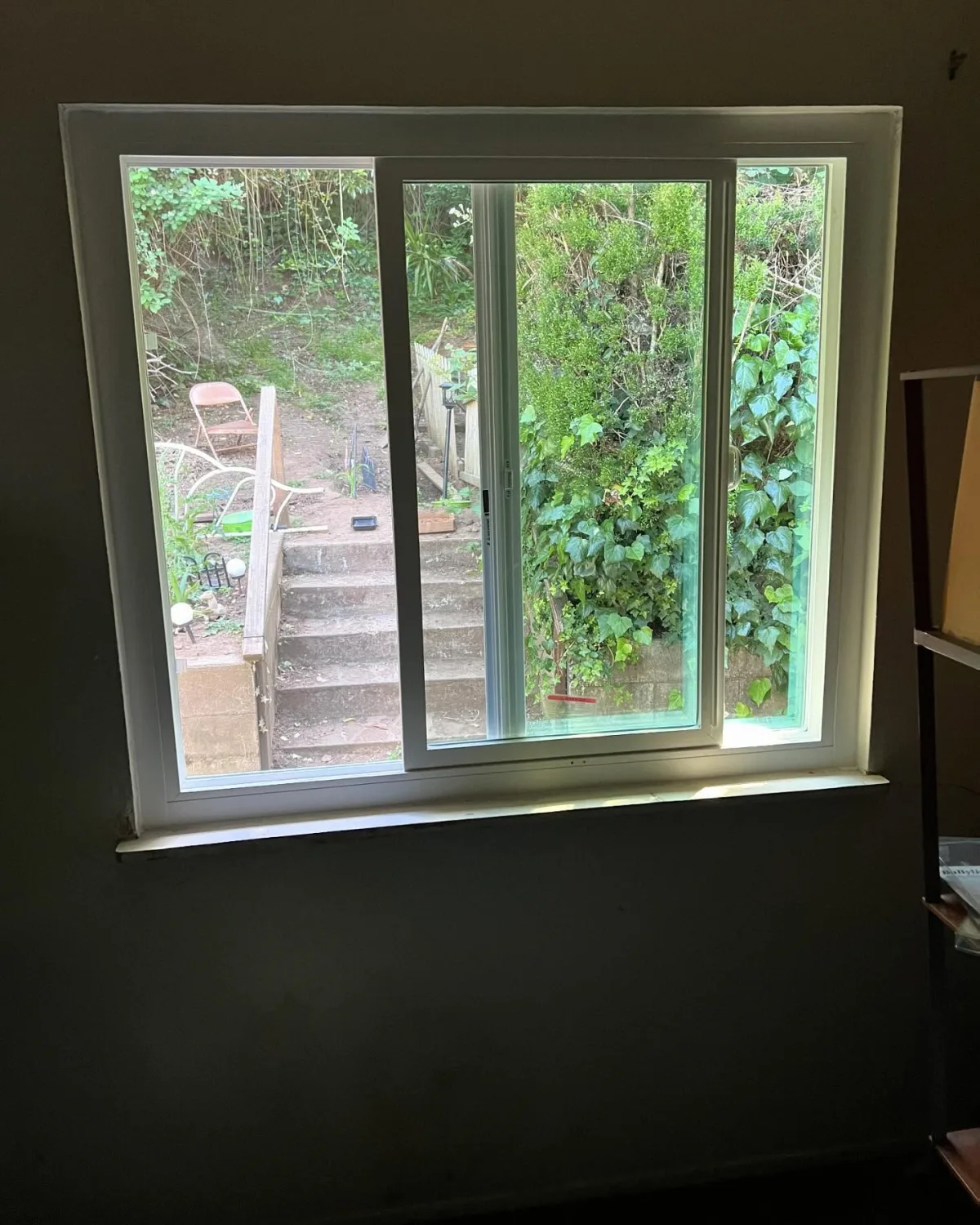 White PlyGem sliding window installed in a residential room in Oakland, CA
